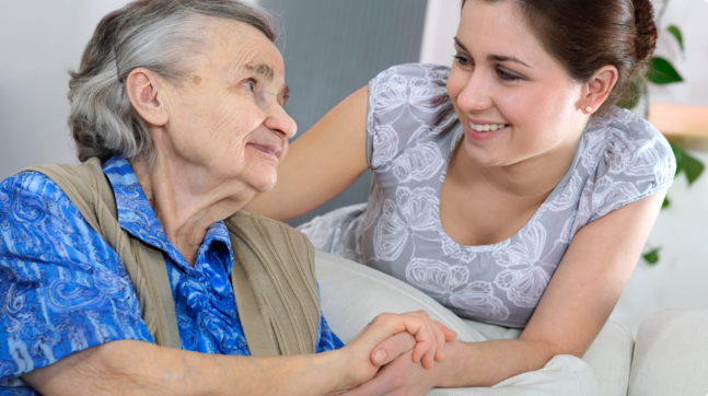 caregiver attending to the elder woman