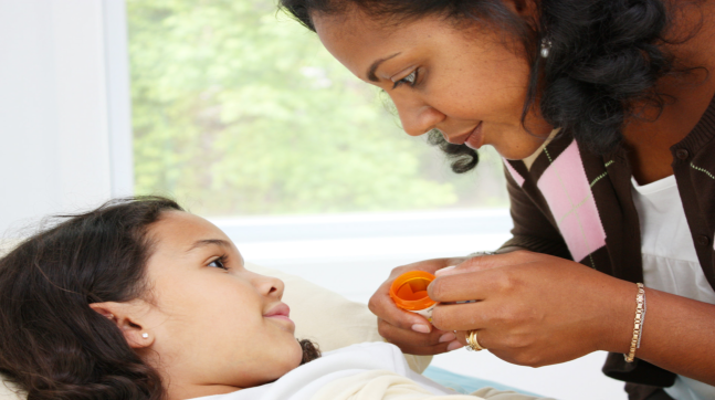 caregiver checking on the little girl