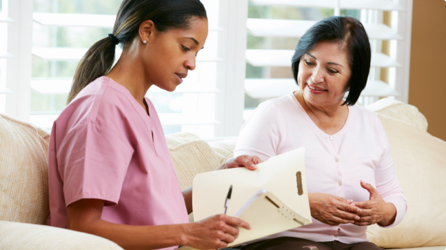 caregiver showing medical results to the elder woman