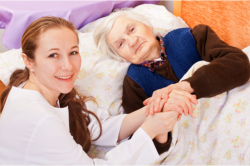 nurse taking care of the bedridden elder lady